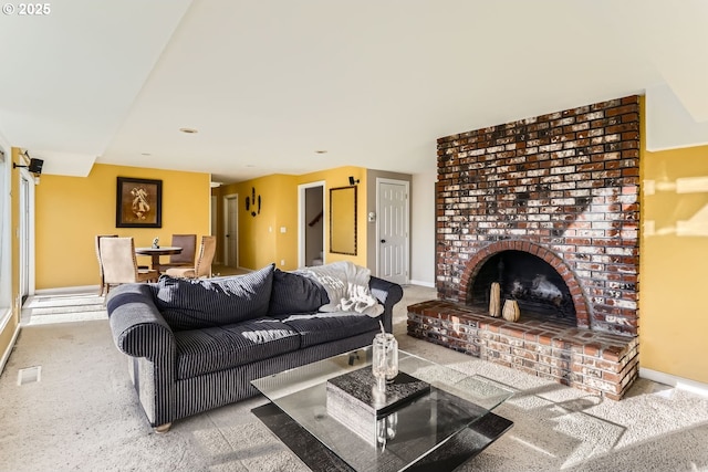 living room featuring light carpet and a brick fireplace