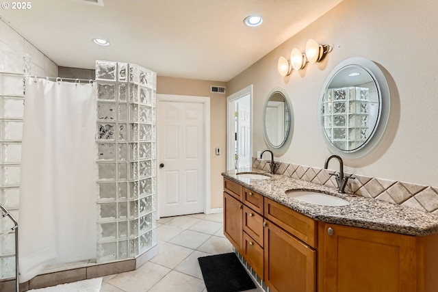 bathroom with vanity, curtained shower, decorative backsplash, and tile patterned flooring