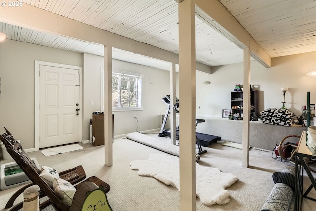 exercise room with light carpet and wooden ceiling