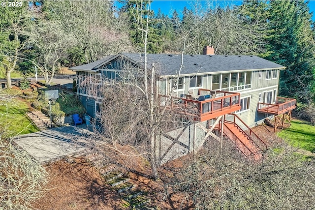 back of house featuring a deck