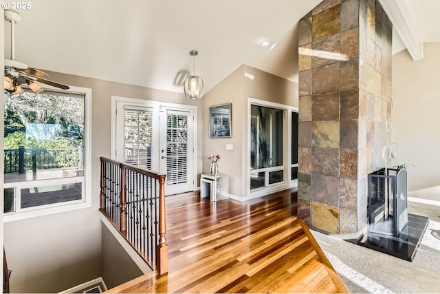 interior space featuring french doors, vaulted ceiling with beams, and dark hardwood / wood-style flooring