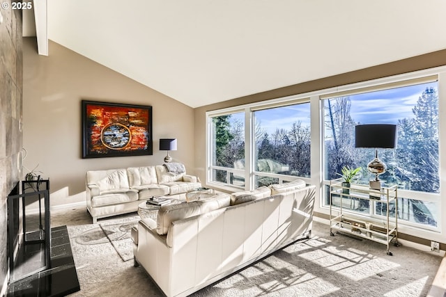 carpeted living room with vaulted ceiling