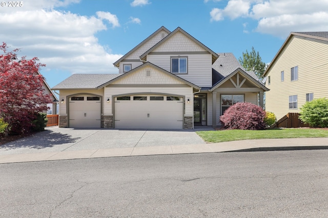 craftsman inspired home with fence, roof with shingles, an attached garage, stone siding, and driveway