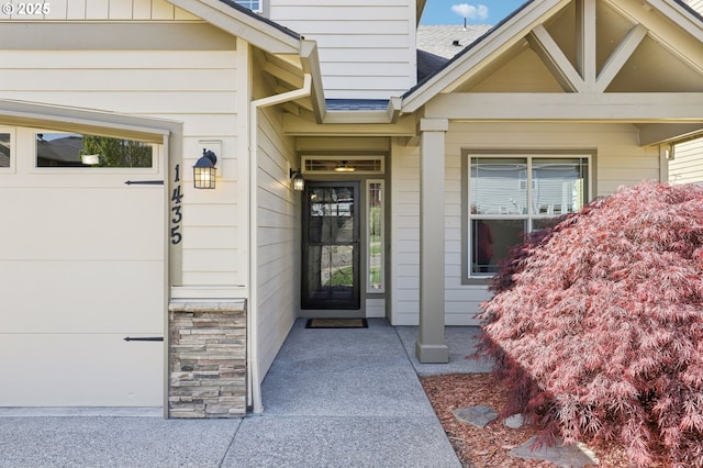 doorway to property featuring roof with shingles