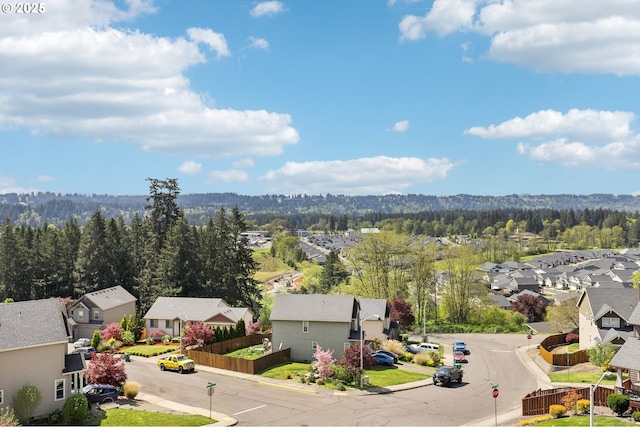 bird's eye view featuring a forest view and a residential view