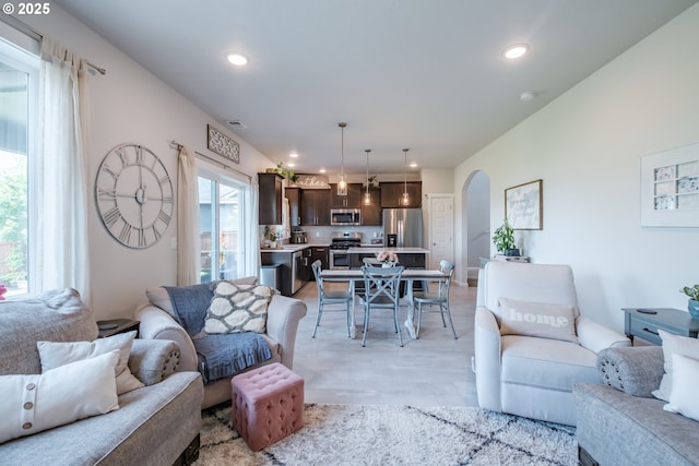 4507 Sagecrest Dr, Albany, OR 97322 - living room with arched walkways, light wood finished floors, and recessed lighting