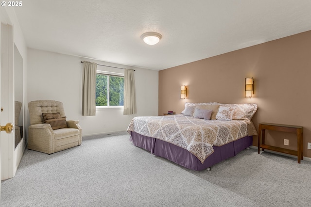 bedroom featuring carpet floors and baseboards