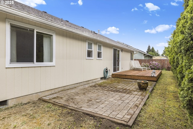 view of yard with a patio, a wooden deck, and fence