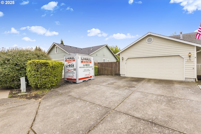 view of home's exterior with fence and a garage