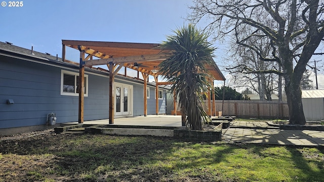 view of yard featuring a patio, french doors, fence, and a pergola