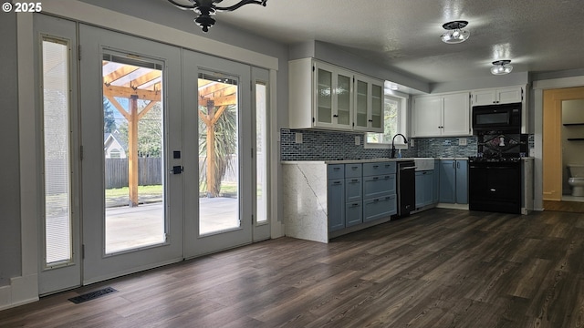 kitchen with dark wood-style flooring, black microwave, electric range oven, and french doors