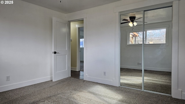 unfurnished bedroom featuring carpet floors, a closet, and baseboards