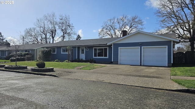 single story home featuring a chimney, concrete driveway, an attached garage, a front yard, and fence