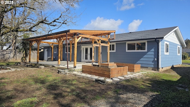 rear view of property featuring french doors, crawl space, a patio area, and a shingled roof