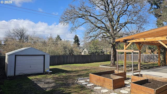 view of yard with a garage, a garden, a fenced backyard, an outbuilding, and a pergola