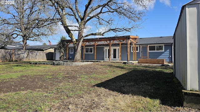 back of house with a yard, french doors, and fence