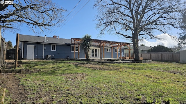 rear view of house with french doors, a yard, a patio area, cooling unit, and a fenced backyard