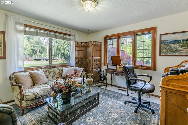 home office with a textured ceiling and baseboards