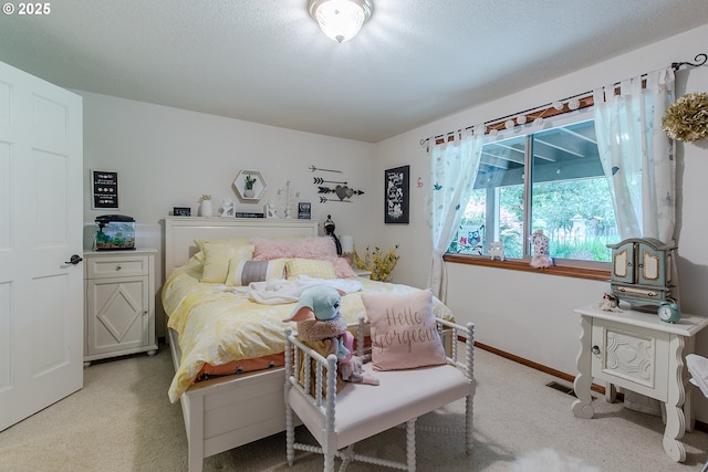 carpeted bedroom with baseboards and visible vents