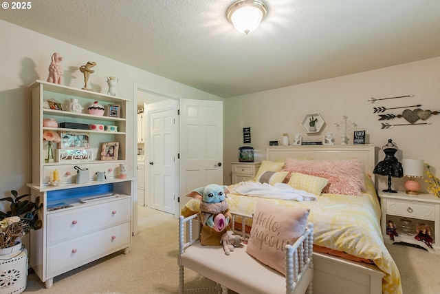 bedroom with vaulted ceiling, light colored carpet, and a textured ceiling