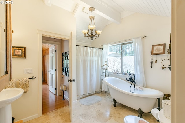 full bathroom with a notable chandelier, a freestanding bath, a shower with shower curtain, and lofted ceiling with beams