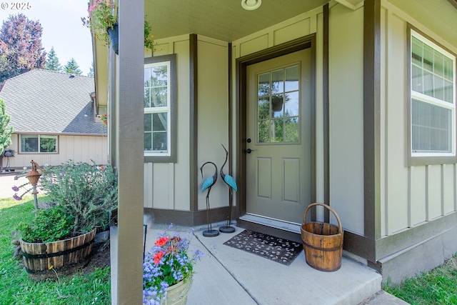 property entrance with board and batten siding and a porch