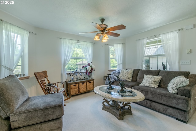 carpeted living room with a ceiling fan