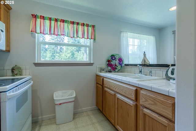 bathroom with vanity and baseboards