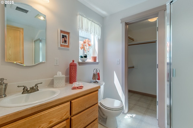 bathroom with vanity, toilet, visible vents, and tile patterned floors