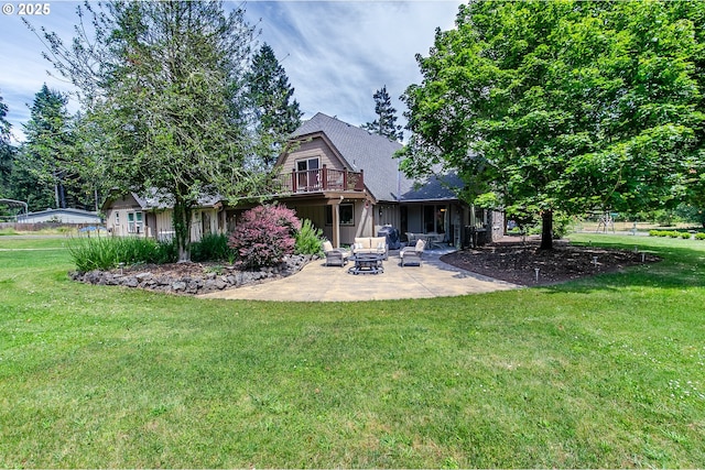rear view of property with a yard and a patio area