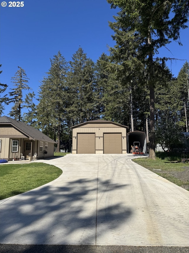 exterior space featuring concrete driveway, board and batten siding, an outdoor structure, and a detached garage