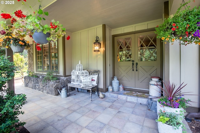 view of exterior entry featuring board and batten siding and a porch