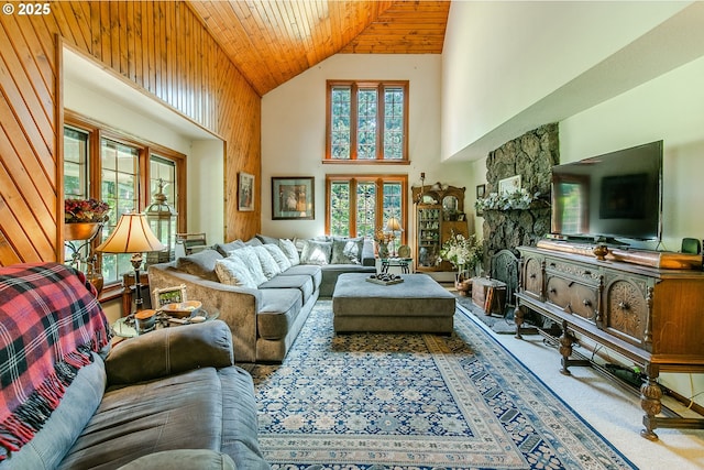 carpeted living room with wooden ceiling, a wealth of natural light, and high vaulted ceiling
