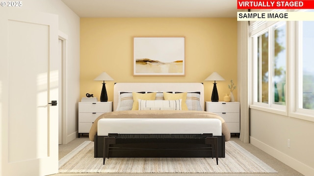 carpeted bedroom with baseboards and multiple windows