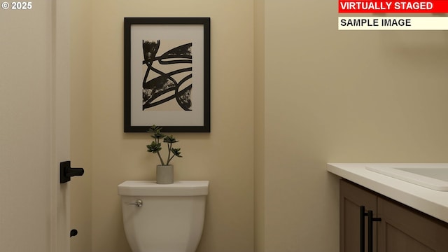 bathroom featuring toilet and vanity