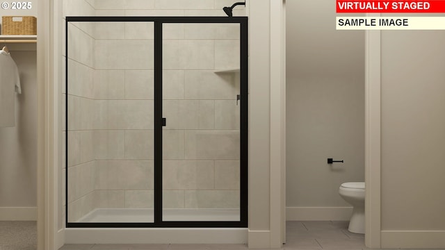 full bathroom featuring toilet, baseboards, a shower stall, and tile patterned flooring