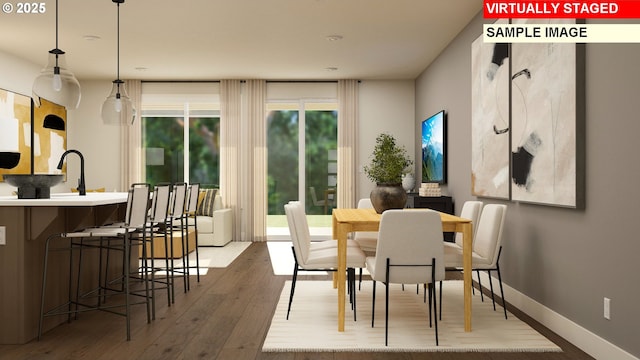 dining area with baseboards and wood-type flooring