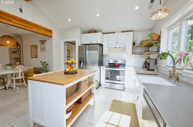 12545 SW Fairfield St, Beaverton, OR 97005 - kitchen featuring open shelves, appliances with stainless steel finishes, under cabinet range hood, wood counters, and recessed lighting
