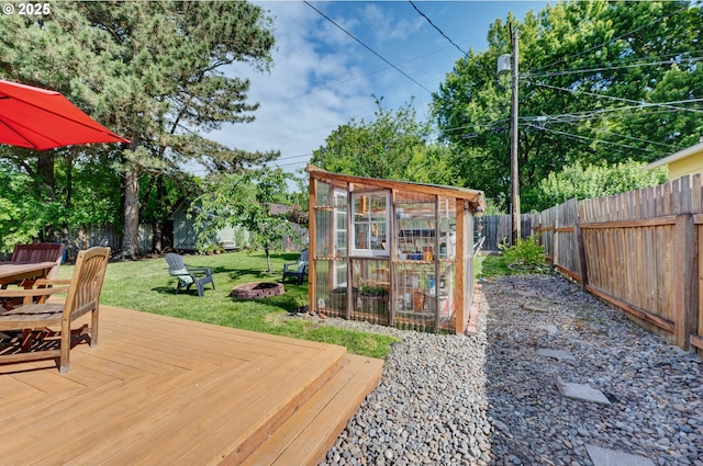 12545 SW Fairfield St, Beaverton, OR 97005 - wooden deck with an exterior structure, a fire pit, and an outdoor structure