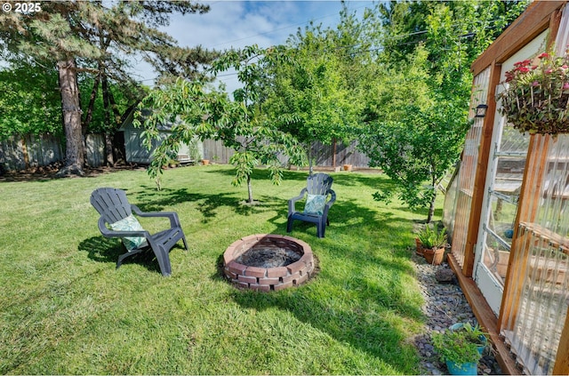 12545 SW Fairfield St, Beaverton, OR 97005 - view of yard featuring a fire pit, a greenhouse, and an outbuilding