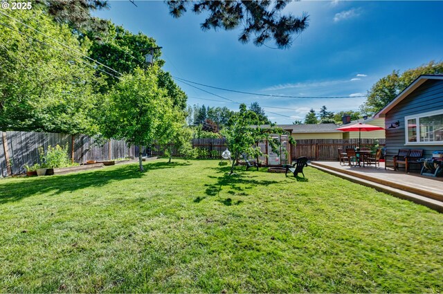 12545 SW Fairfield St, Beaverton, OR 97005 - view of yard featuring a deck, a fire pit, and outdoor dining area
