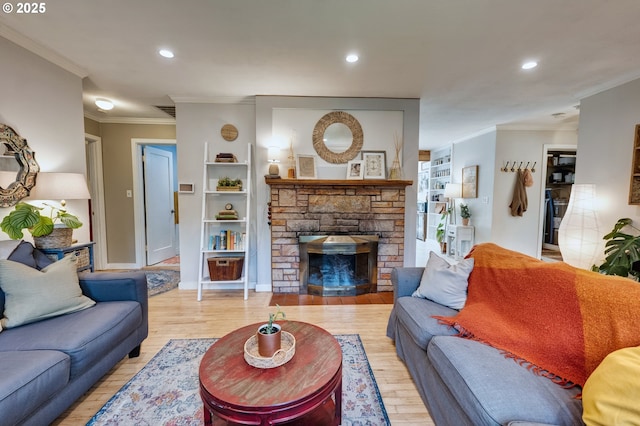12545 SW Fairfield St, Beaverton, OR 97005 - living room featuring crown molding, light wood-style flooring, a stone fireplace, recessed lighting, and baseboards