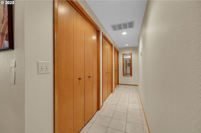 hallway with light tile patterned floors