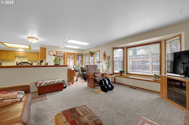 living room with light carpet and a skylight