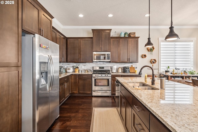 13372 SW Aubergine Ter, Sherwood, OR 97140 - kitchen featuring a sink, appliances with stainless steel finishes, light stone countertops, and tasteful backsplash