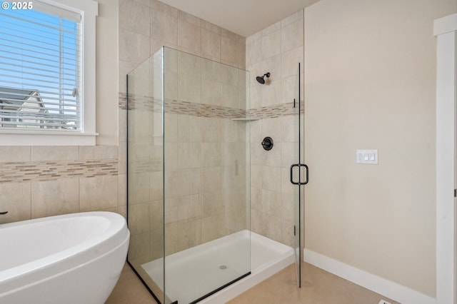 13372 SW Aubergine Ter, Sherwood, OR 97140 - full bathroom featuring tile patterned floors, tile walls, a soaking tub, and a stall shower