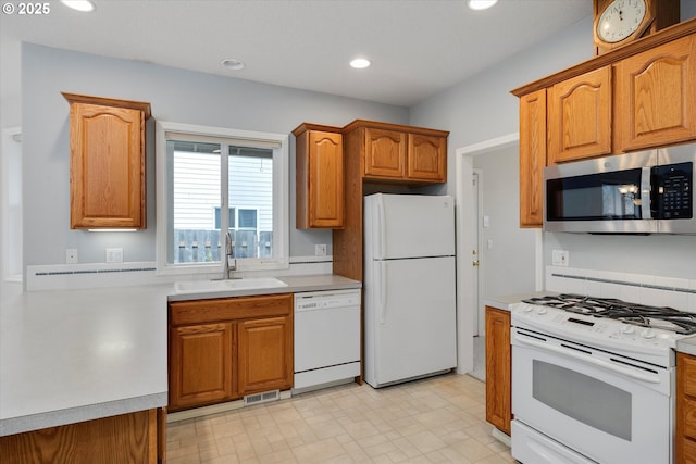 kitchen with sink and white appliances