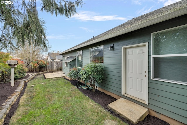 doorway to property with a lawn