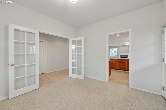 carpeted spare room with french doors