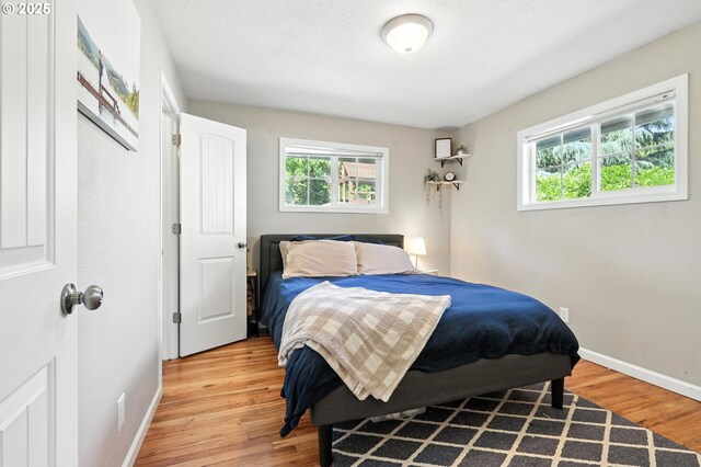 3216 Oakcrest Dr, Forest Grove, OR 97116 - bedroom featuring multiple windows and light wood-style flooring